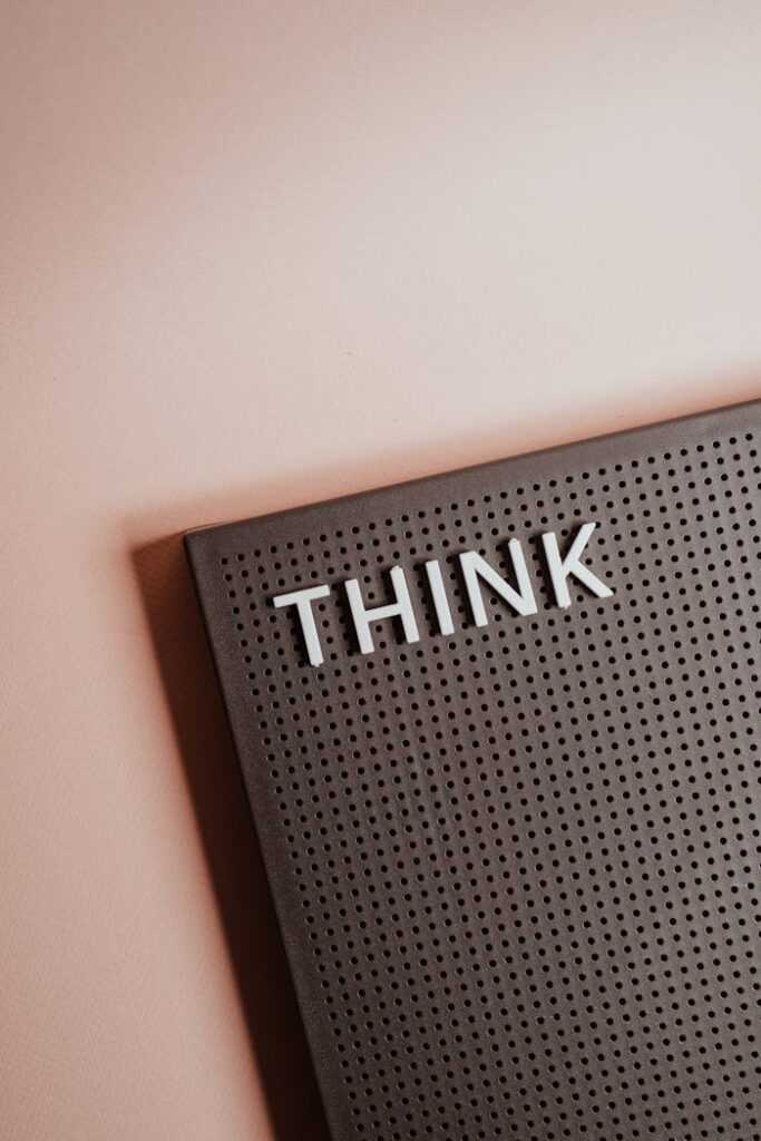 Close-up of a letter board with the word 'THINK' on a soft background.